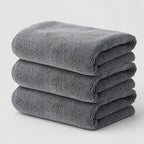 PrimeBuild Microfiber Gym Towels 3 Pack: three grey towels folded and stacked on a light background