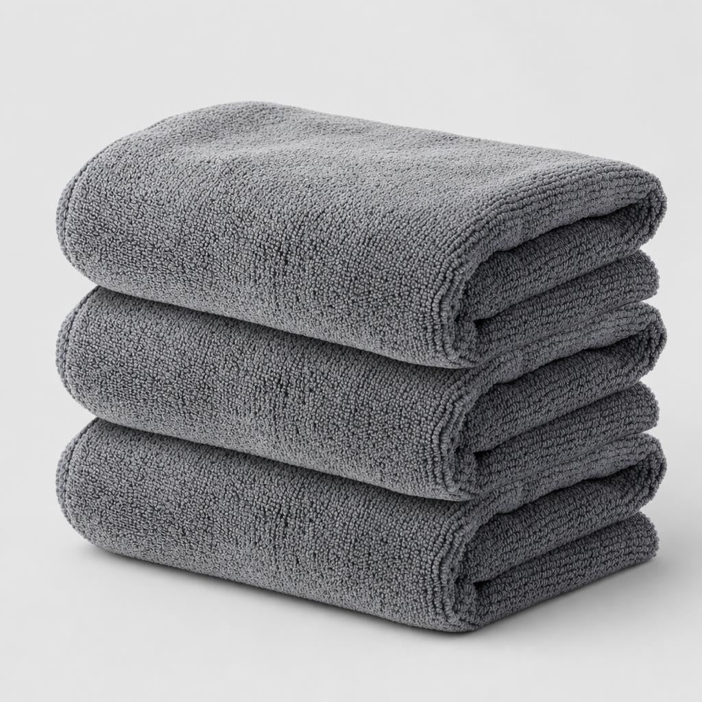 PrimeBuild Microfiber Gym Towels 3 Pack: three grey towels folded and stacked on a light background