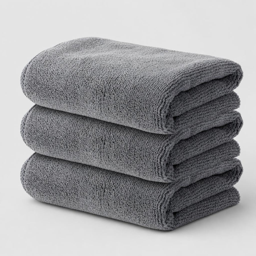 PrimeBuild Microfiber Gym Towels 3 Pack: three grey towels folded and stacked on a light background