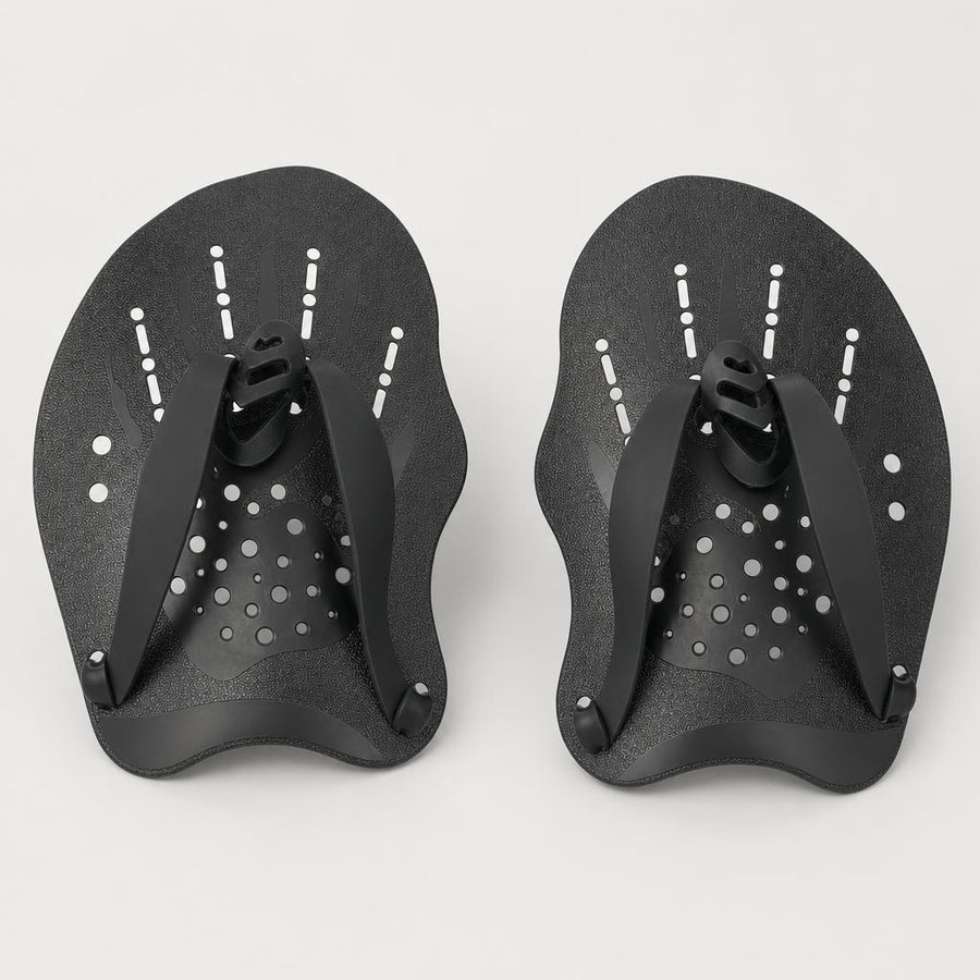 PrimeBuild Swim Hand Paddles in black, top view of the textured blades with drainage holes, finger loops and straps