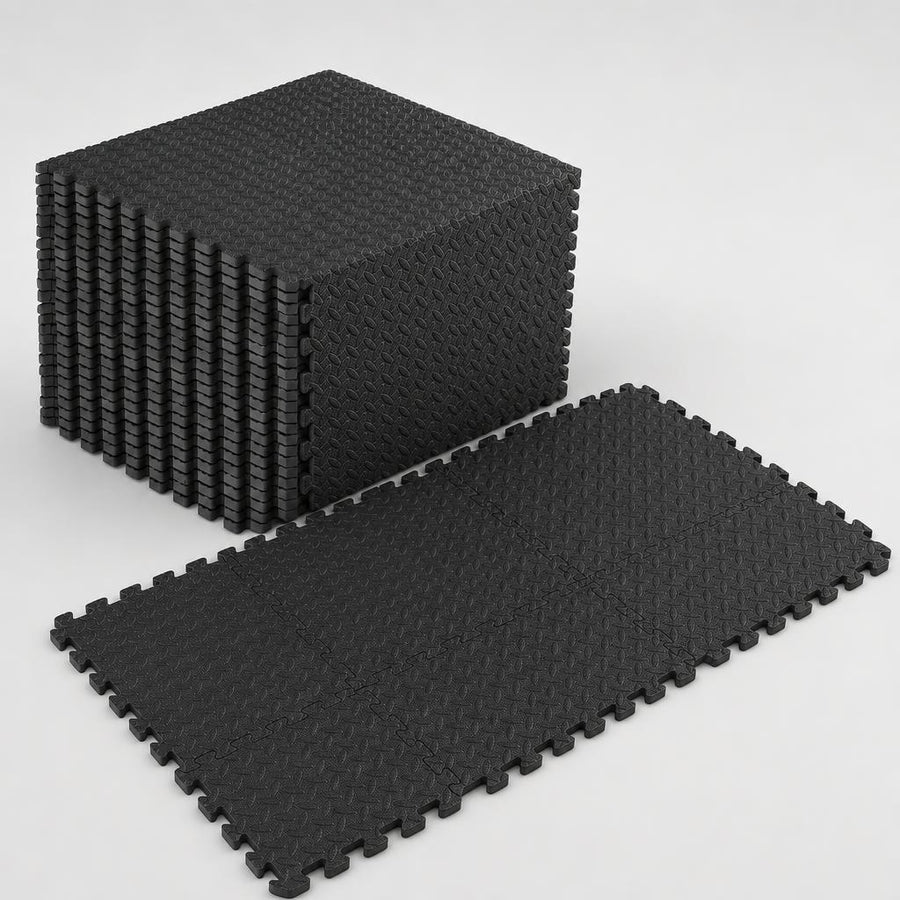 PrimeBuild Interlocking Foam Gym Mat in black, a stack of tiles beside six tiles joined into a flat puzzle floor