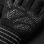 Close-up of a black PrimeBuild Workout Glove palm with silicone dot grip and striped elastic wrist wrap