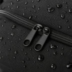 Close-up of the PrimeBuild Yoga Mat Carry Bag zipper with double pulls on black fabric with water droplets