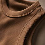 Close-up of the PrimeBuild Women's Ribbed Performance Tank in brown showing the ribbed neckline and armhole trim