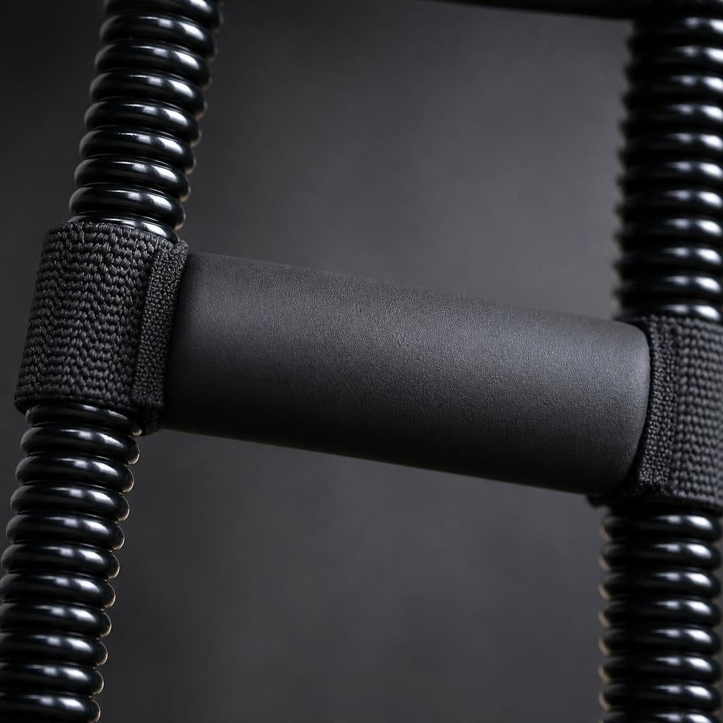 Close-up of the PrimeBuild Wrist Strengthener foam stabilizer pad strapped between the black coiled springs
