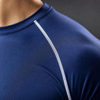 Close-up of the PrimeBuild compression shirt crew neck and white stitched raglan seam on navy fabric