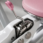 Close-up of the PrimeBuild Split Stretch Machine ratchet gear and pink lever handle under the padded seat