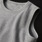 Close-up of the PrimeBuild Men's Stringer Gym Tank in gray showing the stitched crew neckline and armhole edge