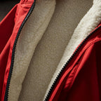 Close-up of the PrimeBuild Swim Parka open front zip showing cream sherpa fleece lining inside the red shell