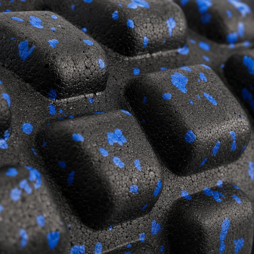 Close-up of the raised knobs on the PrimeBuild High-Density Foam Roller in black foam with blue speckles