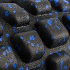 Close-up of the raised knobs on the PrimeBuild High-Density Foam Roller in black foam with blue speckles