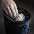 PrimeBuild Climbing Chalk Bag close-up: hand reaching into the lined opening toward the white chalk ball