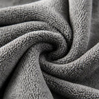 Close-up of the textured surface of a swirled grey PrimeBuild microfiber gym towel