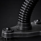 Close-up of the PrimeBuild Arm Wrestling Wrist Trainer black coiled spring column and suction-cup base