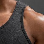 Close-up of the PrimeBuild Men's Quick-Dry Training Tank scoop neckline and shoulder strap in dark heathered knit