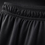 Close-up of the gathered elastic waistband and smooth black fabric of PrimeBuild Men's Performance Training Shorts