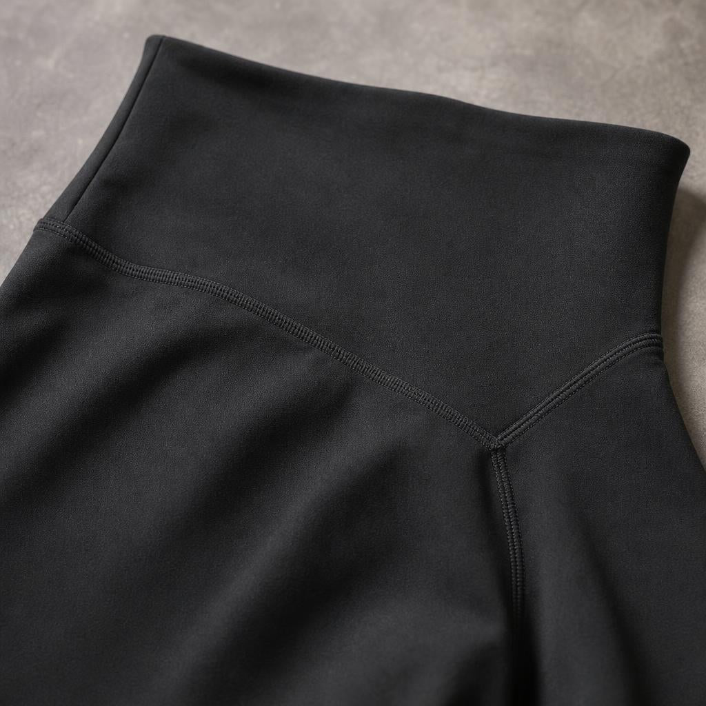Close-up of PrimeBuild Women's Sculpt Shorts in black showing the wide waistband and stitched V-shaped back seam
