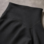 Close-up of PrimeBuild Women's Sculpt Shorts in black showing the wide waistband and stitched V-shaped back seam