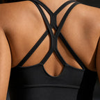 Close-up of the PrimeBuild Women's Longline Sports Bra in black: double crisscross back straps and rounded back cutout