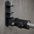 PrimeBuild Wall-Mounted Landmine Attachment close-up on a concrete wall, star knob on the sleeve and a barbell end inserted