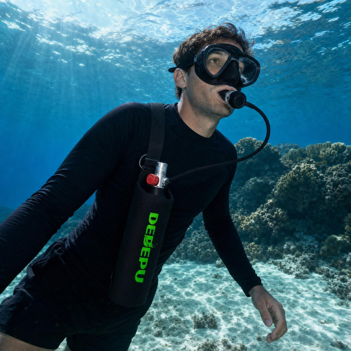 Snorkeler breathing from the DEDEPU mini scuba tank in its sling bag over a shallow reef